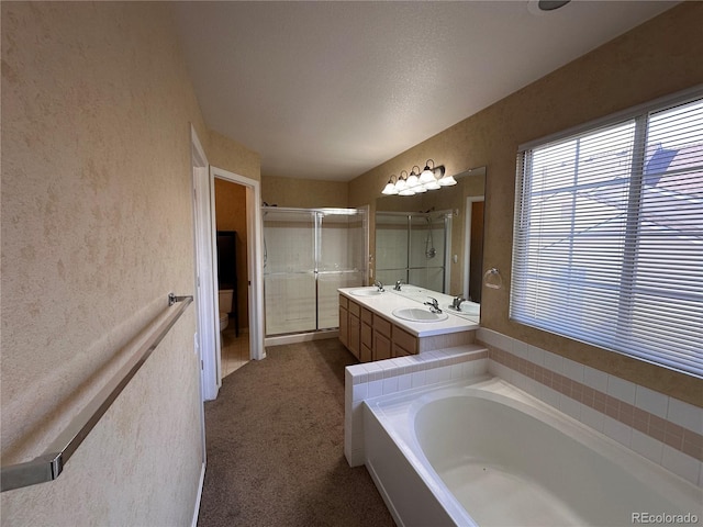 full bathroom with vanity, shower with separate bathtub, and toilet