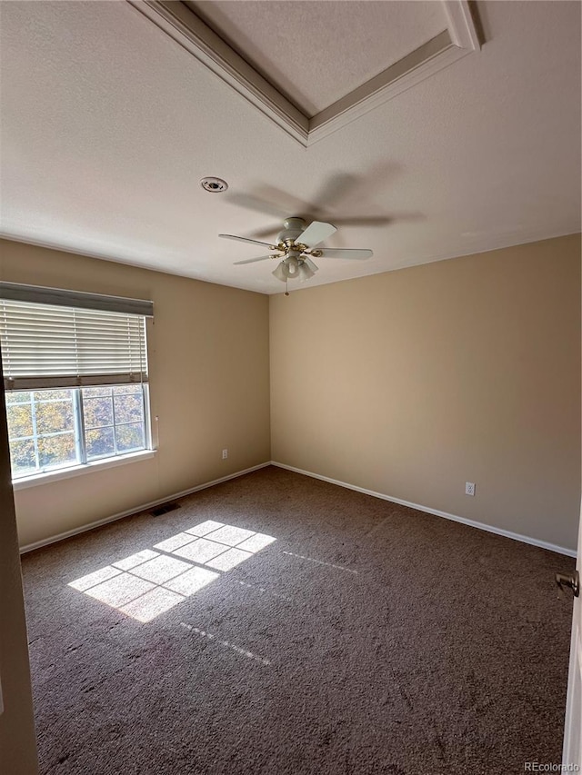 empty room with ceiling fan, a textured ceiling, and carpet floors