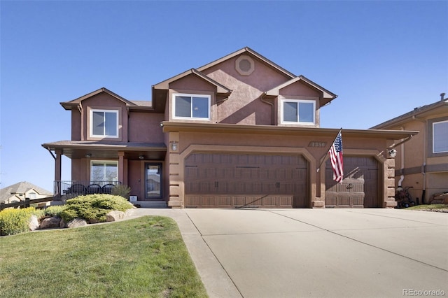 view of front of property featuring driveway, an attached garage, a front yard, and stucco siding
