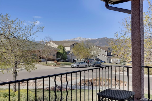 balcony featuring a residential view and a mountain view