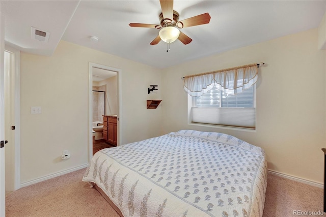 carpeted bedroom featuring baseboards, a ceiling fan, and ensuite bath
