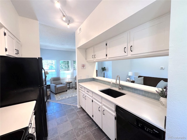 4760 S Wadsworth Blvd Unit F105, Littleton, CO 80123 - kitchen featuring black appliances, a sink, white cabinetry, light countertops, and dark tile patterned floors