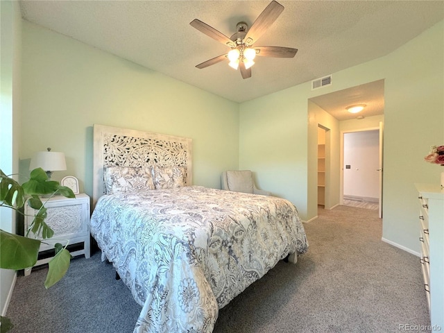 4760 S Wadsworth Blvd Unit F105, Littleton, CO 80123 - bedroom with carpet floors, baseboards, ceiling fan, and a textured ceiling