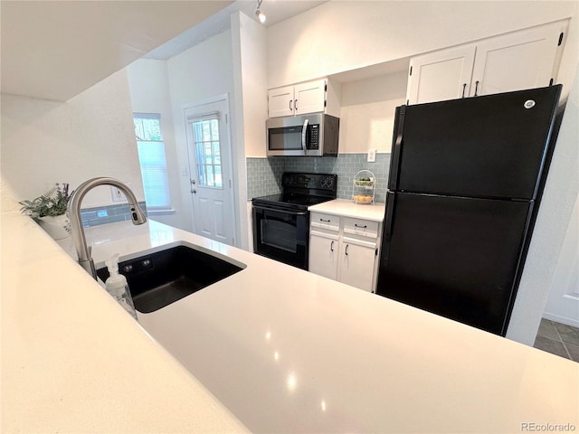 4760 S Wadsworth Blvd Unit F105, Littleton, CO 80123 - kitchen featuring black appliances, white cabinetry, light countertops, and tasteful backsplash