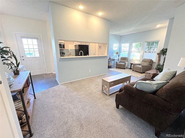 4760 S Wadsworth Blvd Unit F105, Littleton, CO 80123 - living room featuring dark colored carpet, plenty of natural light, a textured ceiling, and recessed lighting