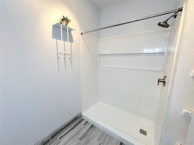 4760 S Wadsworth Blvd Unit F105, Littleton, CO 80123 - full bath with a shower stall, wood finished floors, and a textured wall