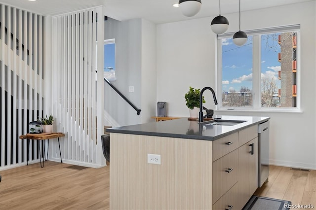 3101 W 47th Ave Unit 14, Denver, CO 80211 - kitchen with light wood-type flooring, dishwasher, dark countertops, hanging light fixtures, and modern cabinets
