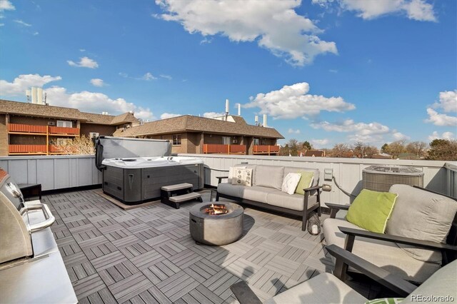 3101 W 47th Ave Unit 14, Denver, CO 80211 - view of patio / terrace with a hot tub and an outdoor living space with a fire pit