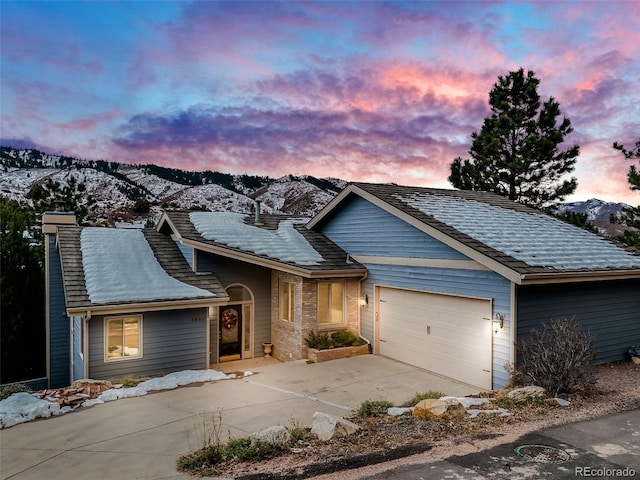 view of front of house with a mountain view and a garage