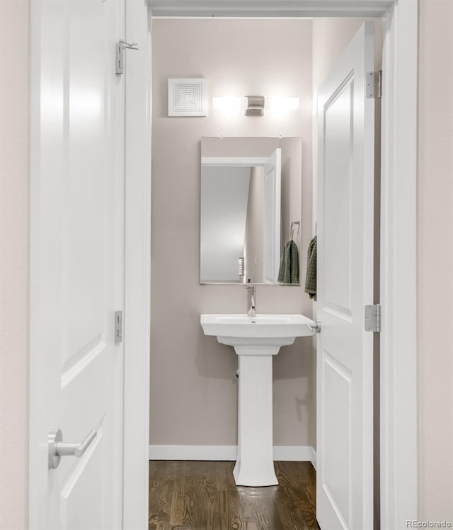 bathroom with baseboards and wood finished floors