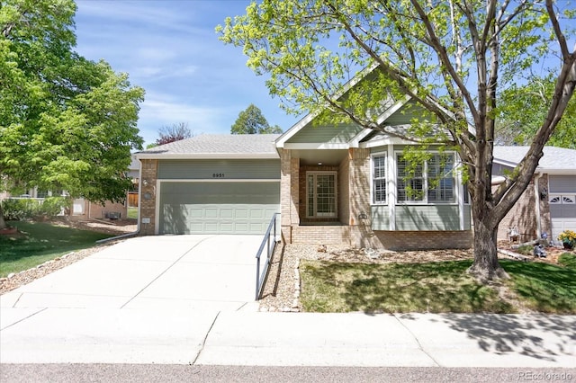 8951 Greenwich St, Highlands Ranch, CO 80130 - single story home featuring an attached garage, brick siding, and concrete driveway