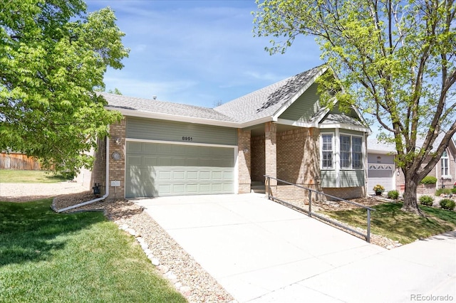 8951 Greenwich St, Highlands Ranch, CO 80130 - ranch-style home with brick siding, an attached garage, driveway, and a front lawn
