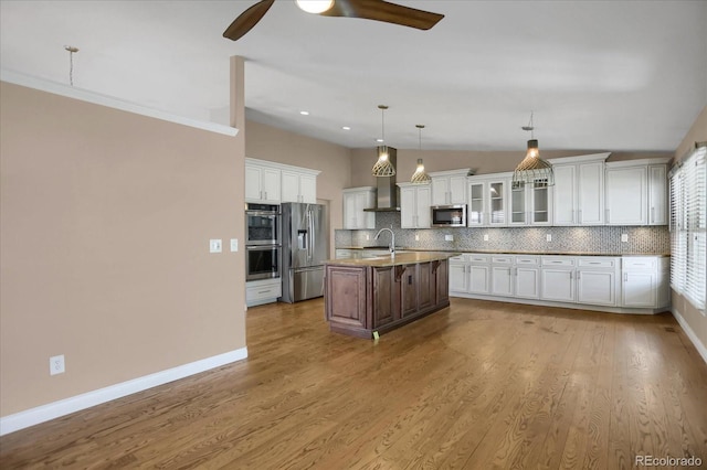 8951 Greenwich St, Highlands Ranch, CO 80130 - kitchen featuring appliances with stainless steel finishes, a sink, ceiling fan, backsplash, and lofted ceiling