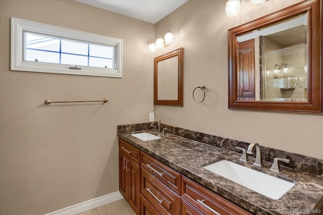 8951 Greenwich St, Highlands Ranch, CO 80130 - bathroom featuring double vanity, a shower with door, and baseboards