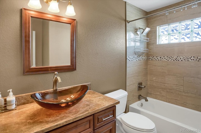 8951 Greenwich St, Highlands Ranch, CO 80130 - bathroom with vanity, toilet, shower / bathtub combination, and a textured wall