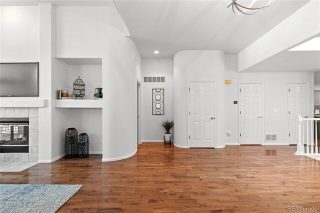 9491 Southern Hills Cir, Lone Tree, CO 80124 - living area with recessed lighting, wood finished floors, and a tiled fireplace