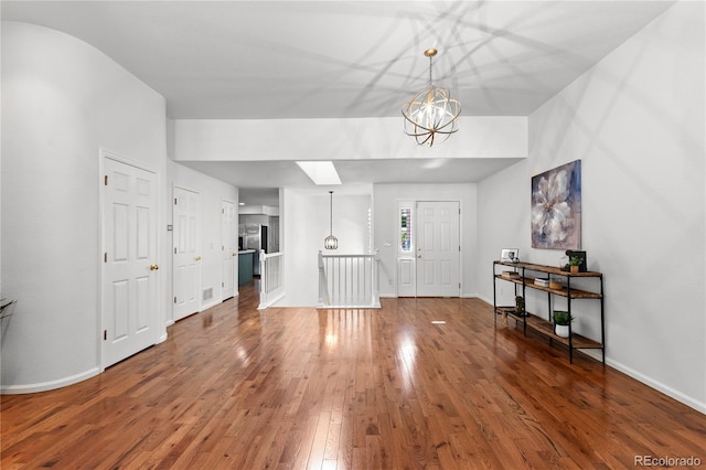 9491 Southern Hills Cir, Lone Tree, CO 80124 - entryway featuring wood finished floors and a chandelier