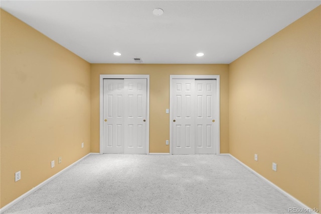 9491 Southern Hills Cir, Lone Tree, CO 80124 - unfurnished bedroom featuring two closets, carpet flooring, and recessed lighting