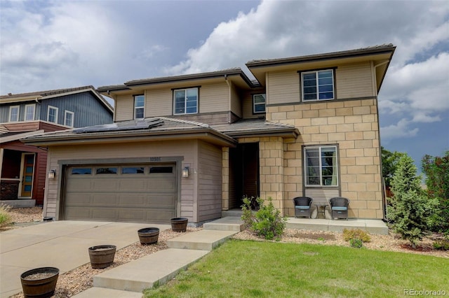 10906 Touchstone Loop, Parker, CO 80134 - view of front of house with roof mounted solar panels, concrete driveway, an attached garage, and a front lawn