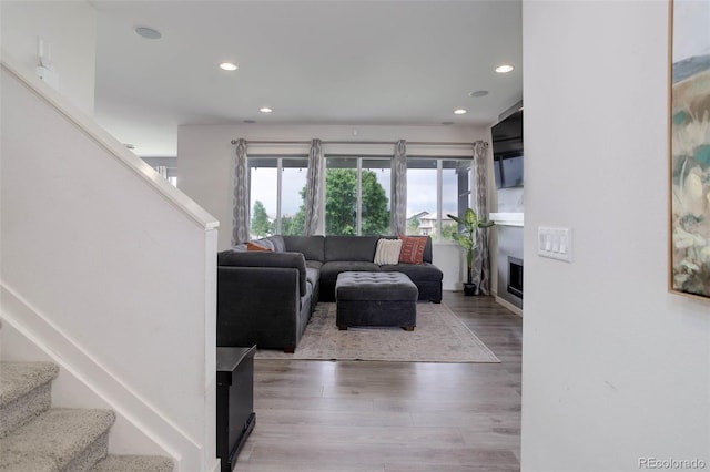 10906 Touchstone Loop, Parker, CO 80134 - living area featuring stairs, recessed lighting, wood finished floors, and a fireplace