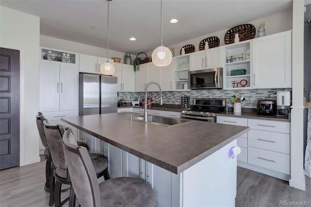 10906 Touchstone Loop, Parker, CO 80134 - kitchen featuring stainless steel appliances, open shelves, dark countertops, backsplash, and light wood-type flooring