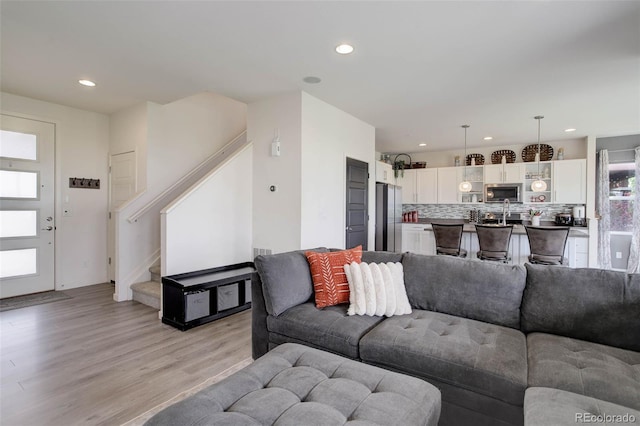 10906 Touchstone Loop, Parker, CO 80134 - living room featuring light wood-style flooring, recessed lighting, and stairway
