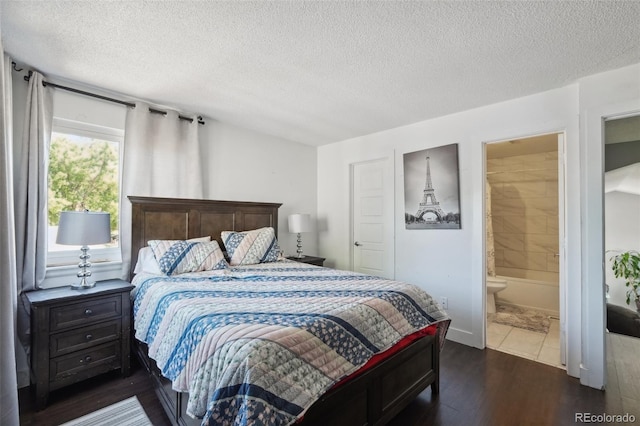 21111 E 43rd Ave, Denver, CO 80249 - bedroom with dark wood-type flooring, a textured ceiling, and ensuite bath