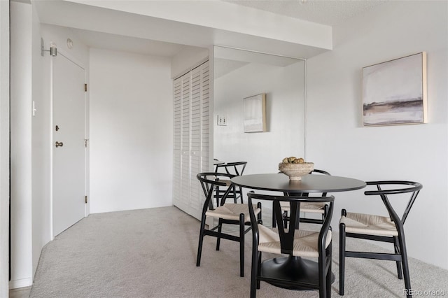 dining area featuring light colored carpet