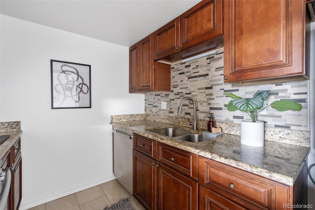 kitchen with sink, tasteful backsplash, light tile patterned floors, stainless steel dishwasher, and stone counters