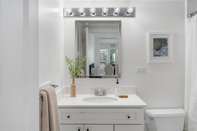 bathroom featuring vanity and toilet