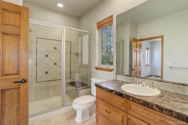 full bath with vanity, toilet, and a shower stall