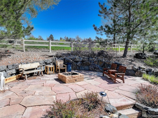 view of patio / terrace with an outdoor fire pit and fence
