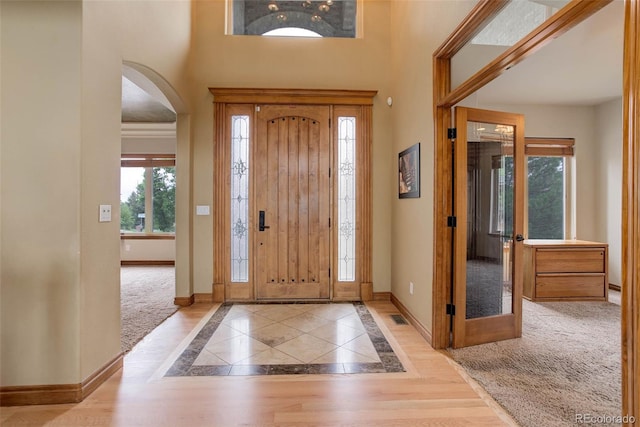 12825 W 81st Ave, Arvada, CO 80005 - foyer with baseboards, arched walkways, inlaid floor details, and a high ceiling