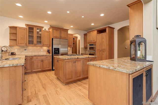 12825 W 81st Ave, Arvada, CO 80005 - kitchen with open shelves, a sink, stainless steel appliances, arched walkways, and recessed lighting