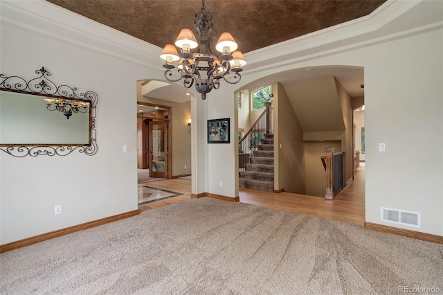 12825 W 81st Ave, Arvada, CO 80005 - empty room with arched walkways, carpet flooring, a chandelier, and a raised ceiling