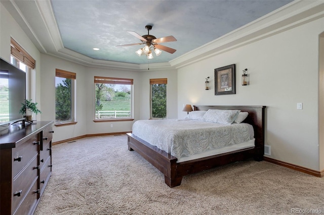 12825 W 81st Ave, Arvada, CO 80005 - bedroom featuring a raised ceiling, carpet flooring, baseboards, multiple windows, and crown molding