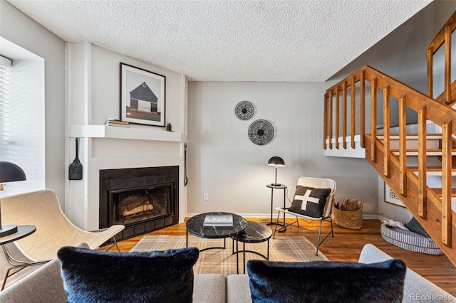 living room with hardwood / wood-style flooring and a textured ceiling