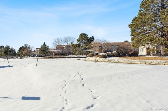 yard covered in snow with volleyball court