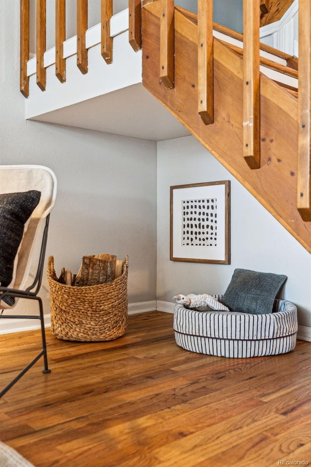 sitting room with baseboards and wood finished floors