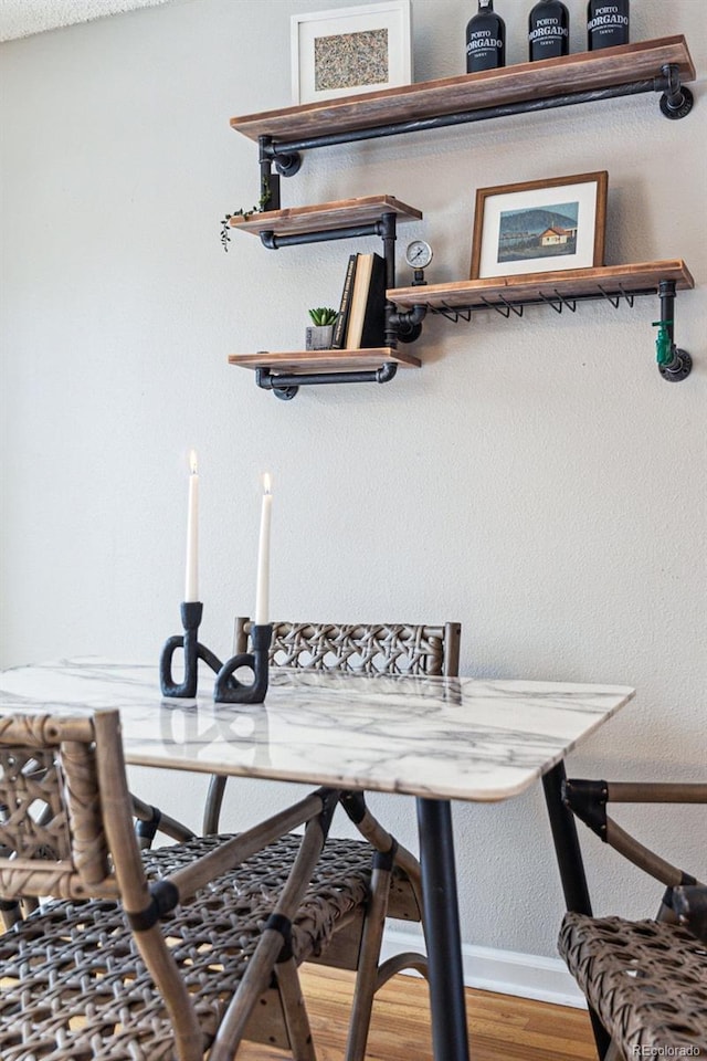 dining room with baseboards and wood finished floors