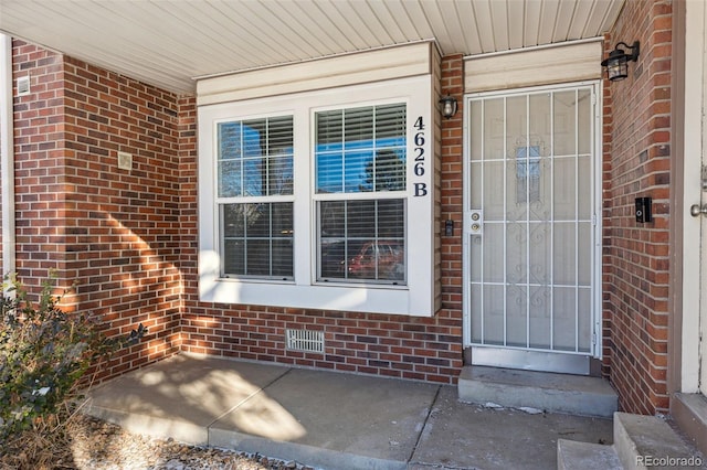 property entrance with brick siding