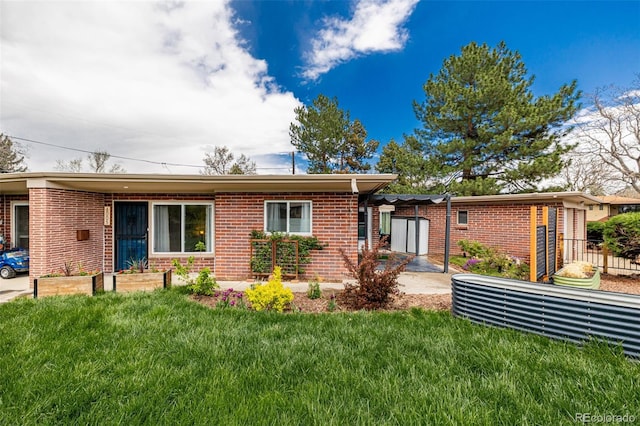 6005 W 39th Ave Unit 6005, Wheat Ridge, CO 80033 - ranch-style home featuring a front yard, brick siding, and fence