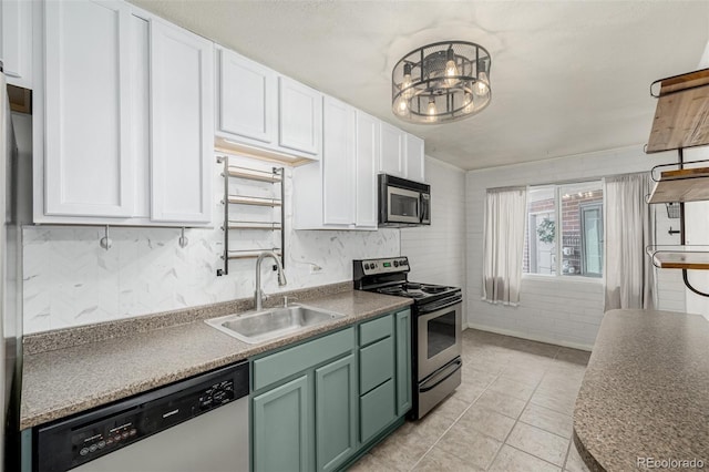 6005 W 39th Ave Unit 6005, Wheat Ridge, CO 80033 - kitchen with green cabinets, light tile patterned flooring, a sink, white cabinets, and appliances with stainless steel finishes