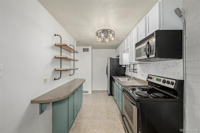 6005 W 39th Ave Unit 6005, Wheat Ridge, CO 80033 - kitchen with an inviting chandelier, visible vents, stainless steel electric range, open shelves, and green cabinetry