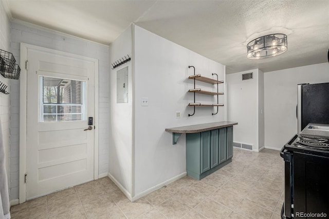 6005 W 39th Ave Unit 6005, Wheat Ridge, CO 80033 - kitchen with freestanding refrigerator, visible vents, electric panel, and black range with electric cooktop