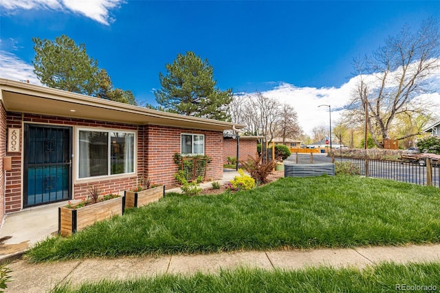 6005 W 39th Ave Unit 6005, Wheat Ridge, CO 80033 - view of side of property with fence and brick siding