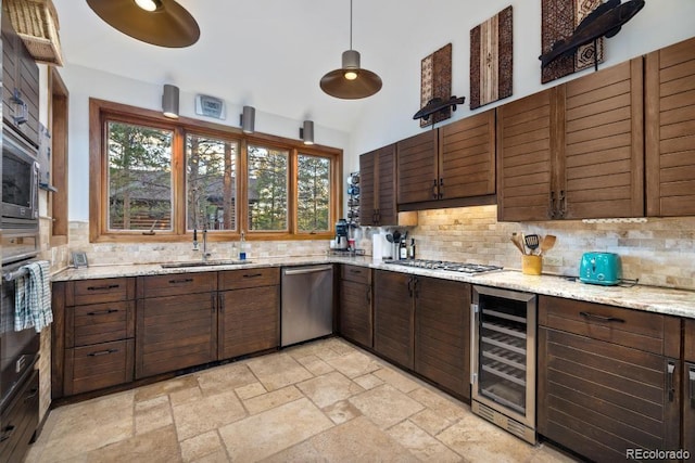 82 Lenawee Ln, Dillon, CO 80435 - kitchen with wine cooler, stainless steel appliances, a sink, backsplash, and vaulted ceiling