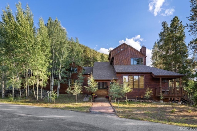 82 Lenawee Ln, Dillon, CO 80435 - view of front facade with a chimney, stairs, and a shingled roof
