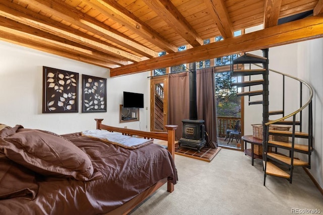 82 Lenawee Ln, Dillon, CO 80435 - bedroom featuring wooden ceiling with exposed beams, a wood stove, carpet flooring, and access to exterior