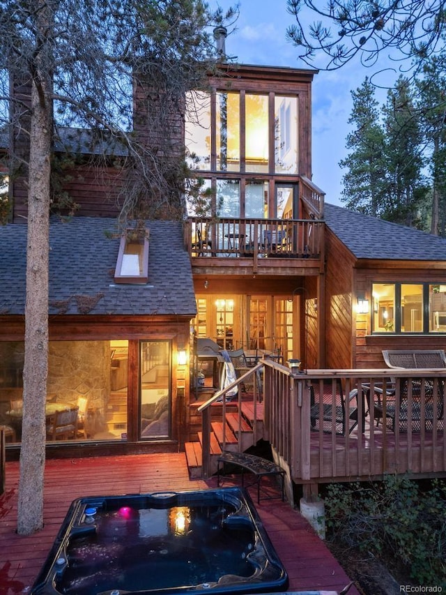 82 Lenawee Ln, Dillon, CO 80435 - rear view of house with a shingled roof, a wooden deck, a chimney, and a balcony